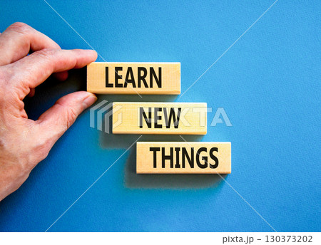 Learn new things symbol. Concept words Learn new things on beautiful wooden blocks. Beautiful blue background. Businessman hand. Business motivational learn new things concept. Copy space. Learn new things symbol. Concept words Learn new things on beautiful wooden blocks. Beautiful blue background. Businessman hand. Business motivational learn new things concept. Copy space. 130373202