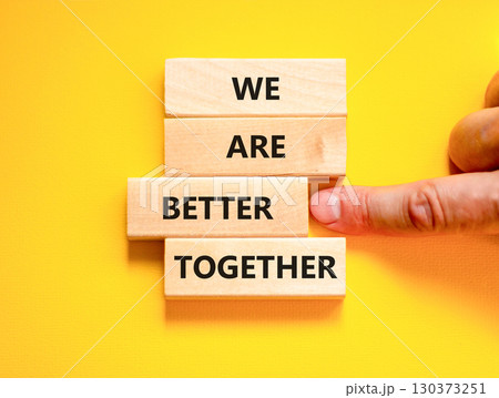 We are better together symbol. Concept words phrase We are better together on beautiful wooden blocks. Beautiful yellow background. Businessman hand. Business We are better together concept Copy space 130373251