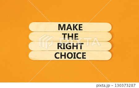 Make the right choice symbol. Concept words phrase Make the right choice on beautiful wooden stick. Beautiful orange paper background. Business Make the right choice concept. Copy space. 130373287