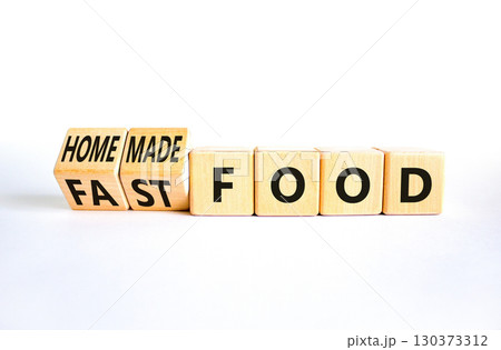 Fast or homemade food symbol. Concept words Fastfood or Homemade food on wooden cubes. Beautiful white table white background. Healthy lifestyle Fast or homemade food concept. Copy space 130373312