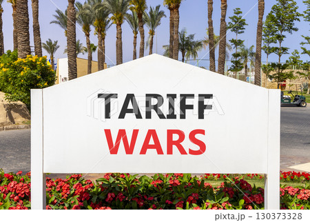 Trade tariff wars symbol. Concept word Tariff wars on beautiful white billboard. Beautiful blue sky and palm tree flowers background. Business trade tariff wars concept concept. Copy space. 130373328