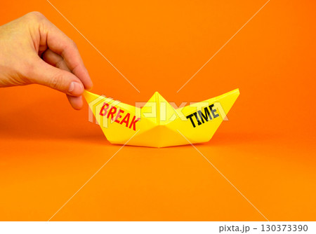 Break time symbol. Concept word Break time on beautiful yellow paper boat. Businessman's hand. Beautiful orange paper background. Business break time concept. Copy space. Break time symbol. Concept word Break time on beautiful yellow paper boat. Businessman's hand. Beautiful orange paper background. Business break time concept. Copy space. 130373390