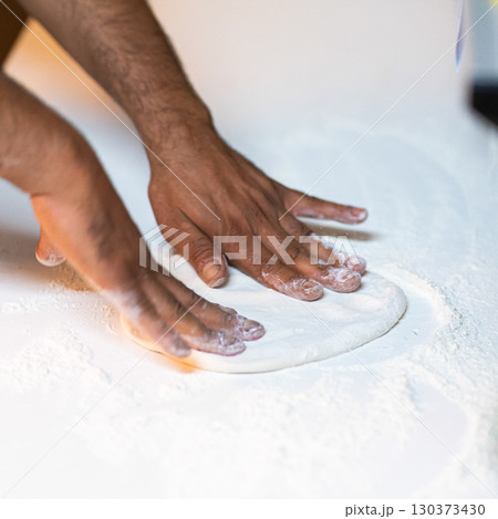 Making pizza dough on board with flour 130373430