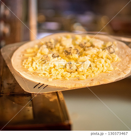 The chef prepares pizza. Raw pizza ready to oven 130373467
