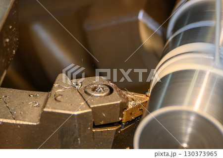 Close up scene the lathe machine finish cut metal shaft parts with liquid coolant method. Close up scene the lathe machine finish cut metal shaft parts with liquid coolant method. 130373965