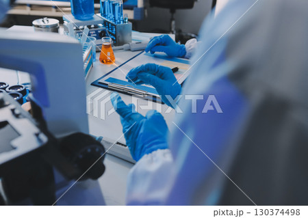Collaboration, tablet or science with people in lab together for research or development. Innovation, tech and microscope with scientist team in clinical trial for planning or medical investigation 130374498