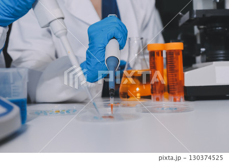 Collaboration, tablet or science with people in lab together for research or development. Innovation, tech and microscope with scientist team in clinical trial for planning or medical investigation 130374525