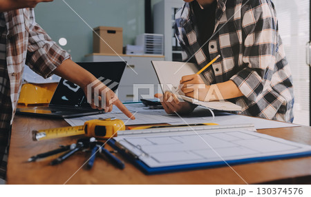 Construction and structure concept of engineer working drawing on blueprint meeting for project working with partner on model building and engineering tools in working site, construction concept. 130374576