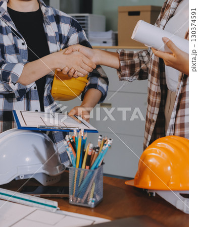 Construction and structure concept of engineer working drawing on blueprint meeting for project working with partner on model building and engineering tools in working site, construction concept. 130374591