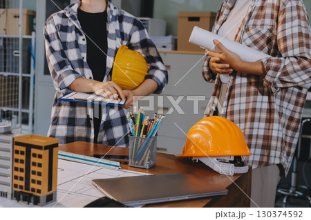 Construction and structure concept of engineer working drawing on blueprint meeting for project working with partner on model building and engineering tools in working site, construction concept. 130374592