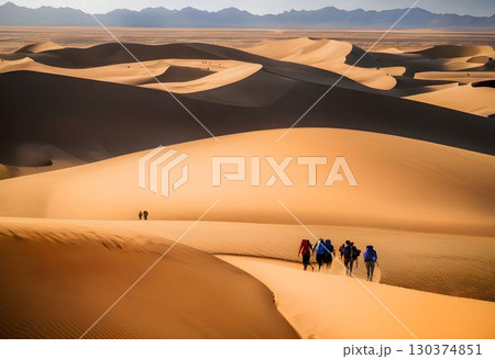 Adventurers Crossing Vast Desert Landscape 130374851