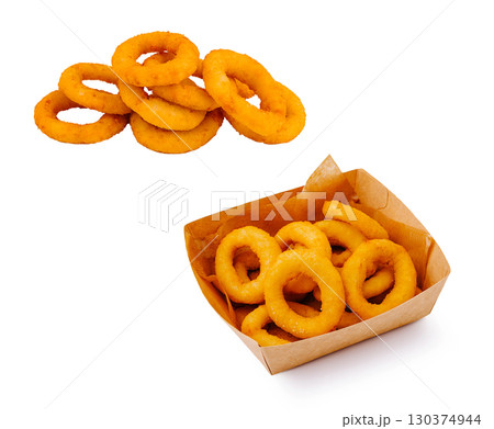 Delicious onion rings served in a paper container and on a plate Delicious onion rings served in a paper container and on a plate 130374944