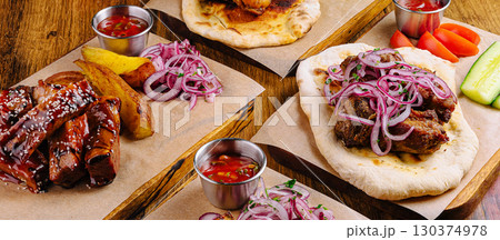 Enjoying a delightful platter of grilled meats and sides in a cozy restaurant 130374978
