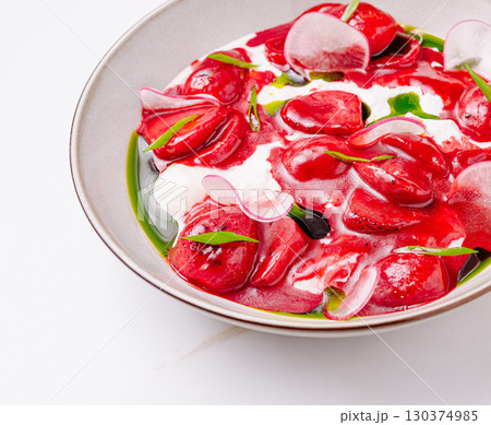 Delicate red strawberry-shaped pasta served in creamy sauce with herbs Delicate red strawberry-shaped pasta served in creamy sauce with herbs 130374985