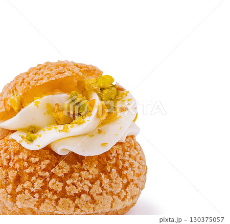 Delicious cream puff topped with citrus and pistachio at a dessert shop Delicious cream puff topped with citrus and pistachio at a dessert shop 130375057