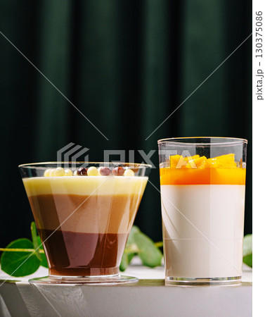 Delicious dessert selection featuring colorful panna cotta and chocolate mousse Delicious dessert selection featuring colorful panna cotta and chocolate mousse 130375086