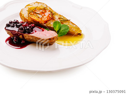 Gourmet duck breast with roasted pear and berry sauce on elegant plate Gourmet duck breast with roasted pear and berry sauce on elegant plate 130375091