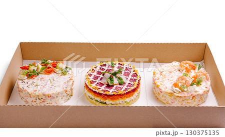 Three visually appealing Russian salads are neatly arranged in a cardboard box Three visually appealing Russian salads are neatly arranged in a cardboard box 130375135