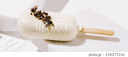 Delicious white chocolate ice cream treat topped with cookie crumbs Delicious white chocolate ice cream treat topped with cookie crumbs 130375142