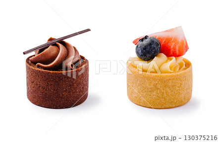 Decadent dessert tarts featuring chocolate and fruit toppings in bright light 130375216