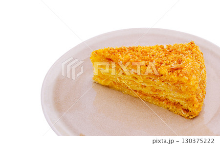 Moist, golden slice of delicious cake on a simple plate with white background Moist, golden slice of delicious cake on a simple plate with white background 130375222