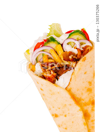 Delicious wrap filled with grilled meat, fresh vegetables, and sauces 130375266