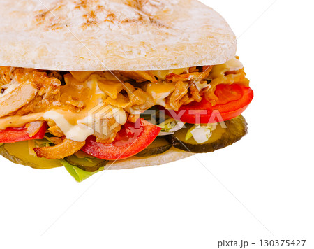 Delicious chicken sandwich with fresh vegetables and savory toppings 130375427