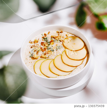 Creamy dessert bowl with sliced fruits and nuts garnished for a fresh look Creamy dessert bowl with sliced fruits and nuts garnished for a fresh look 130375439