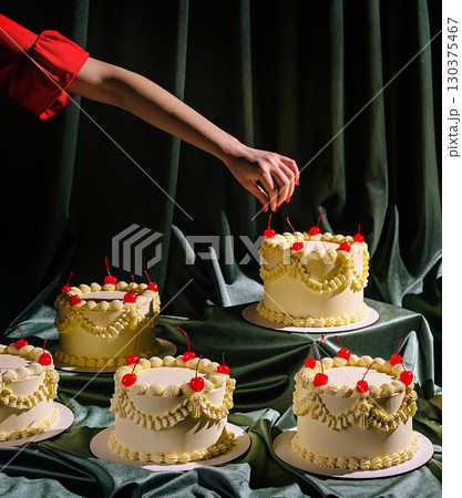 Creative cake decoration in a stylish setting during a festive occasion Creative cake decoration in a stylish setting during a festive occasion 130375467