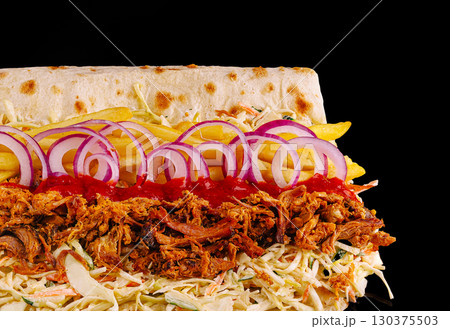 Delicious pulled pork sandwich topped with fresh ingredients and sauces 130375503