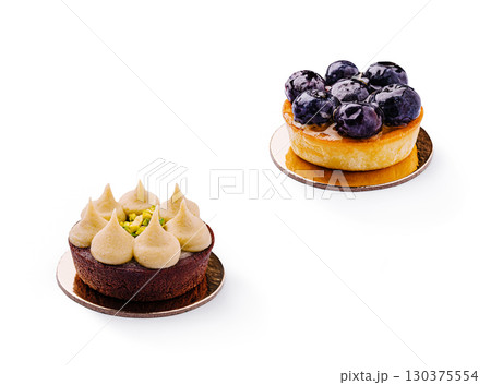 Delicious chocolate and blueberry tarts on a neutral backdrop 130375554