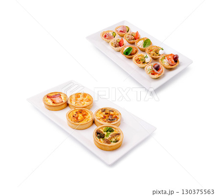 Variety of savory tarts served on rectangular plates at a buffet Variety of savory tarts served on rectangular plates at a buffet 130375563