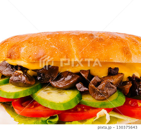 Delicious sandwich with mushrooms, cheese, and fresh vegetables on crusty bread 130375643