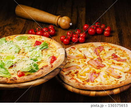 Cozy restaurant serving delicious pizzas on wooden boards Cozy restaurant serving delicious pizzas on wooden boards 130375653