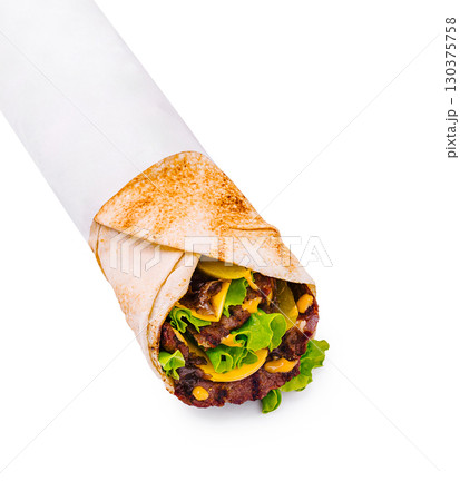 Tasty wrap with fresh veggies and savory meat in a simple style Tasty wrap with fresh veggies and savory meat in a simple style 130375758
