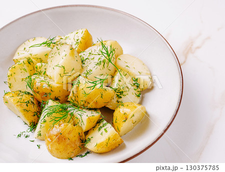 Delicious boiled potatoes garnished with fresh dill in a bowl 130375785