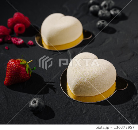 Heart-shaped desserts with fresh fruits on a dark background Heart-shaped desserts with fresh fruits on a dark background 130375957
