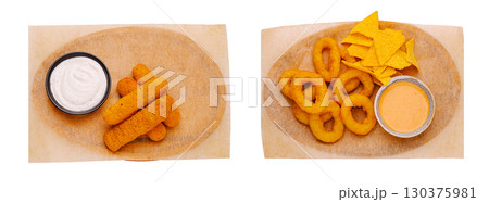 Variety of crispy snacks served with dips on a wooden platter Variety of crispy snacks served with dips on a wooden platter 130375981