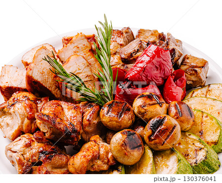 Grilled meat and vegetables platter with aromatic herbs arranged beautifully Grilled meat and vegetables platter with aromatic herbs arranged beautifully 130376041