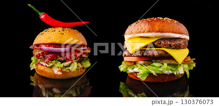 Delicious gourmet burgers with fresh toppings on a black background Delicious gourmet burgers with fresh toppings on a black background 130376073