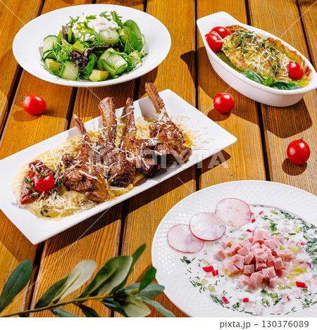 Delicious Mediterranean dishes served on a wooden table 130376089