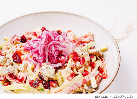 Colorful salad with fresh ingredients and garnished onions at lunchtime 130376119