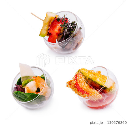 Colorful appetizers served in glass bowls at a modern culinary event Colorful appetizers served in glass bowls at a modern culinary event 130376260