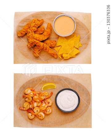 Delicious fried shrimp and crispy tortilla chips served with dip Delicious fried shrimp and crispy tortilla chips served with dip 130376336