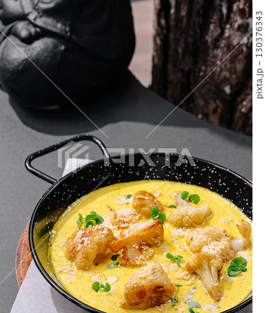 Delicious seafood dish served in a skillet at a cozy outdoor restaurant 130376343