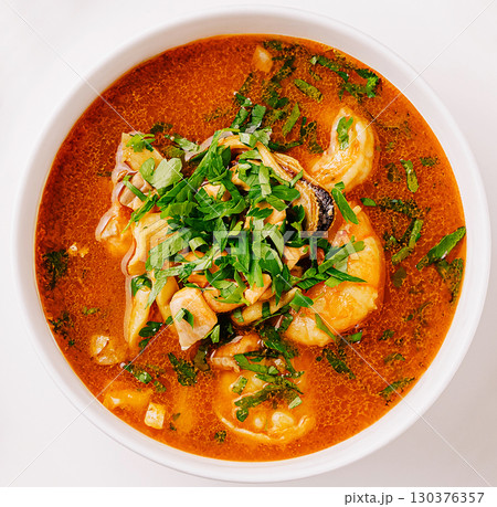 Delicious seafood soup with fresh herbs served in a bowl Delicious seafood soup with fresh herbs served in a bowl 130376357