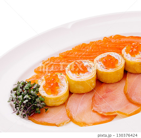 Salmon dishes served on a white platter with garnish in gourmet presentation Salmon dishes served on a white platter with garnish in gourmet presentation 130376424