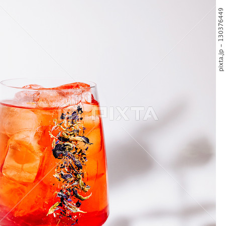 Refreshing herbal iced tea drink served in a glass with ice cubes 130376449