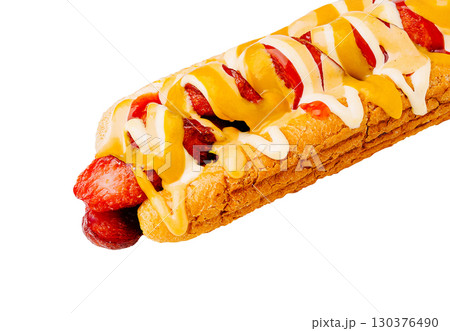 Delicious sausage sandwich with mustard and mayonnaise toppings served on a bun 130376490