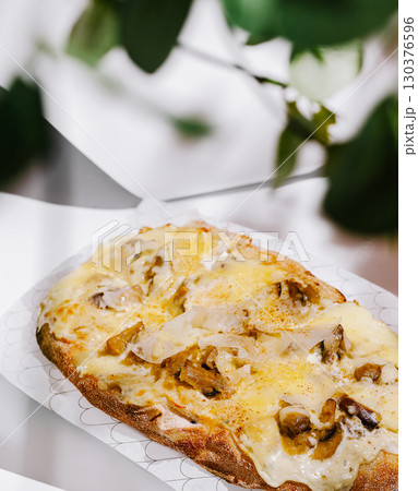 Delicious open-faced sandwich topped with melted cheese and mushrooms Delicious open-faced sandwich topped with melted cheese and mushrooms 130376596